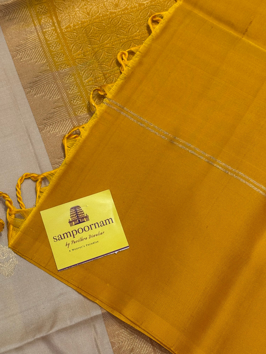 Offwhite with Mustard ,rich zari butta in the body and an elaborate rich Pallu Pure Soft Silk Saree