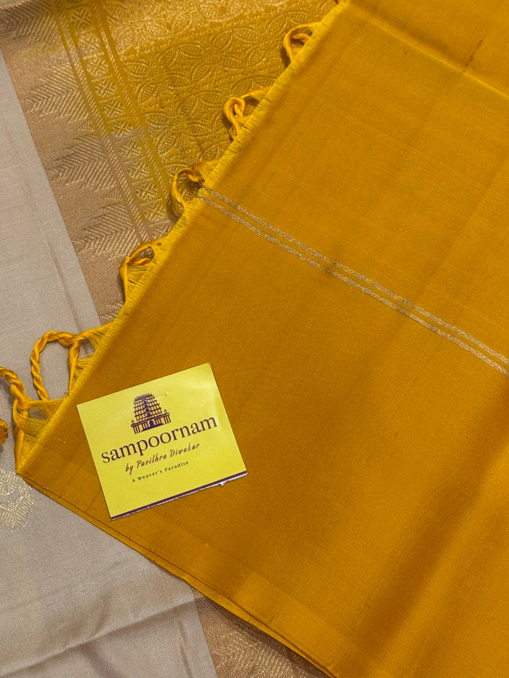 Offwhite with Mustard ,rich zari butta in the body and an elaborate rich Pallu Pure Soft Silk Saree
