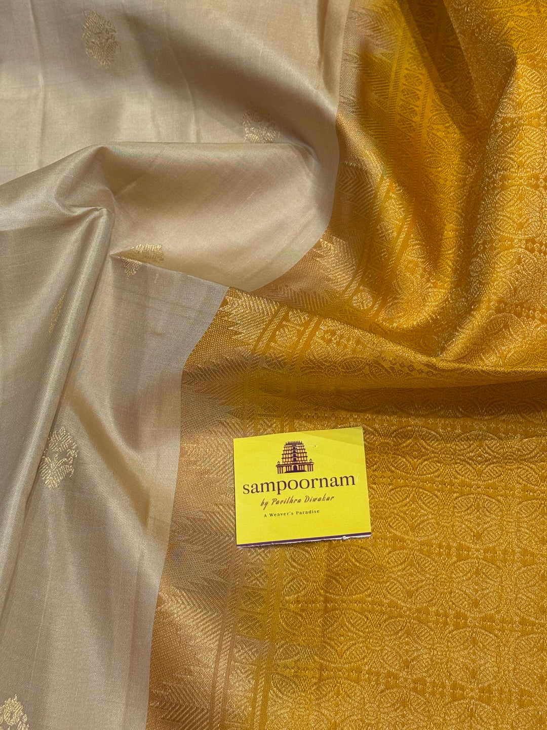 Offwhite with Mustard ,rich zari butta in the body and an elaborate rich Pallu Pure Soft Silk Saree