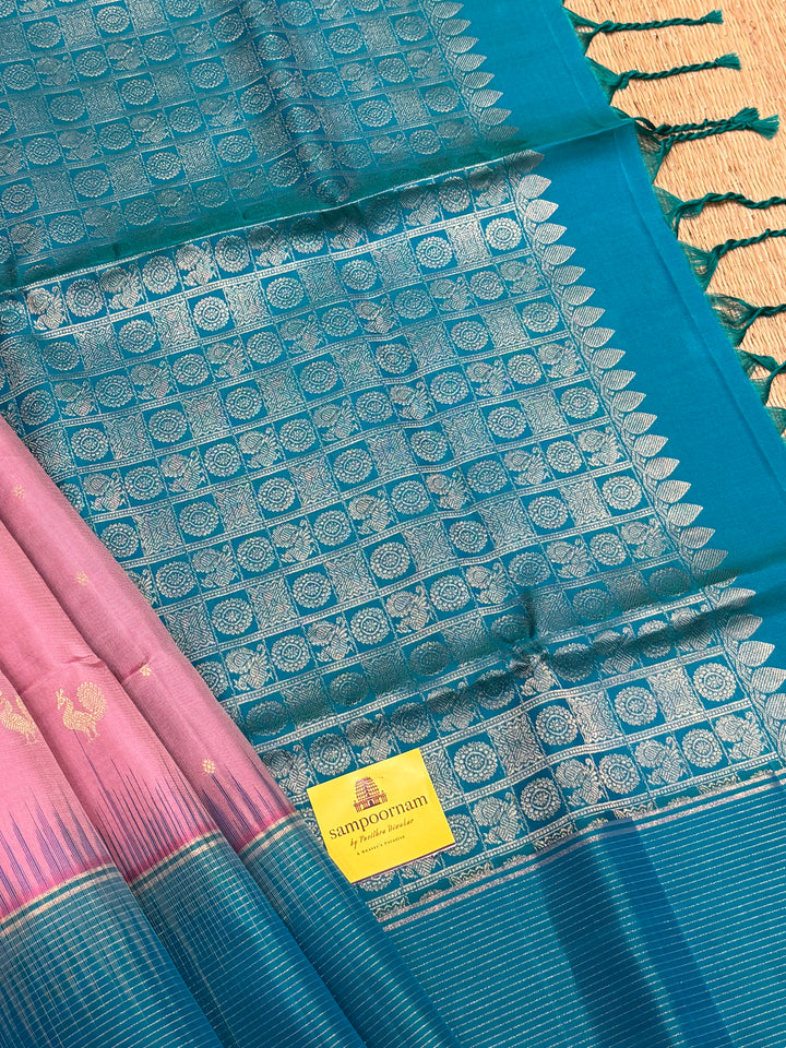 Onion Pink With Turquoise Blue Colour ,vairaoosi lines in the border, rich zari butta in the body and grand traditional Pallu Pure Soft Silk Saree
