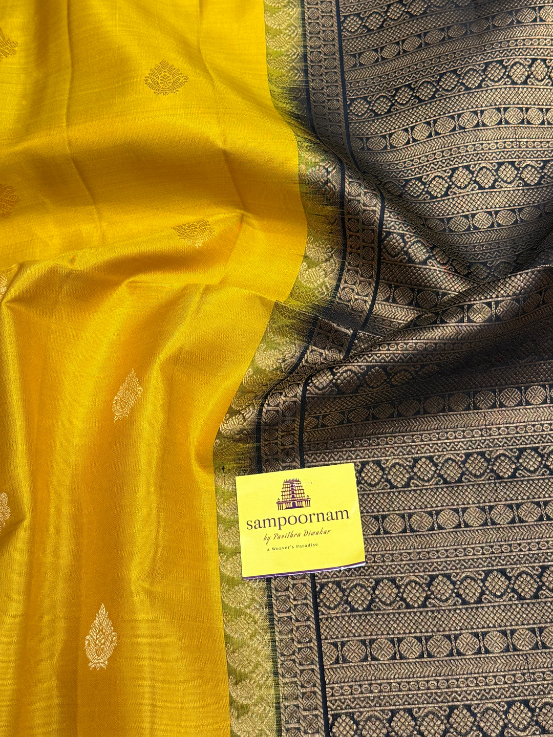 Manjal With Black vairasoosi lines in the border, rich  zari butta in the body and grand traditional Pallu Pure Soft Silk Saree