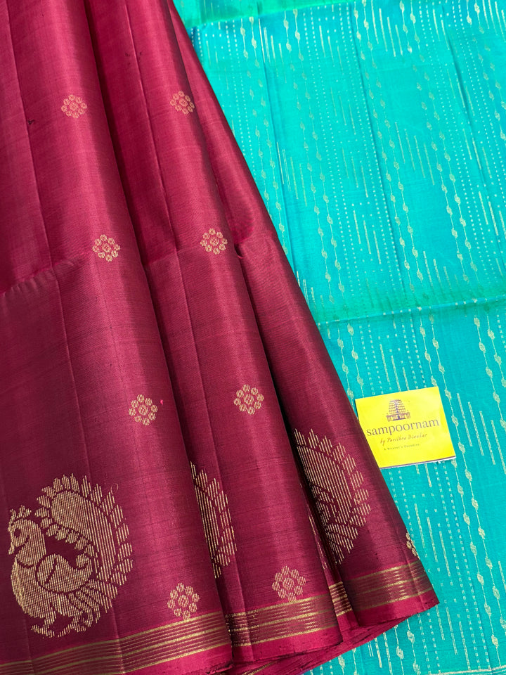 Deep Maroon With Turquoise Blue , rich annam butta in the lower border and small zari buttas in the body, rich Pallu Pure Soft Silk Saree
