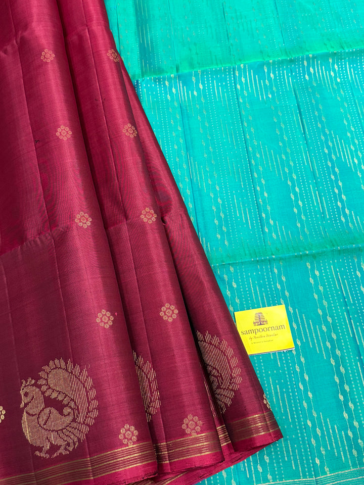 Deep Maroon With Turquoise Blue , rich annam butta in the lower border and small zari buttas in the body, rich Pallu Pure Soft Silk Saree