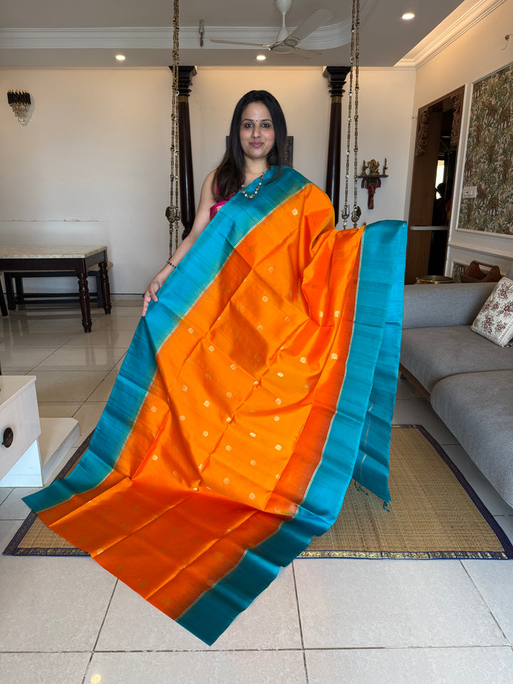 Fanta Orange with Turquoise Blue, rich zari butta in the body and an elaborate rich Pallu Pure Soft Silk Saree