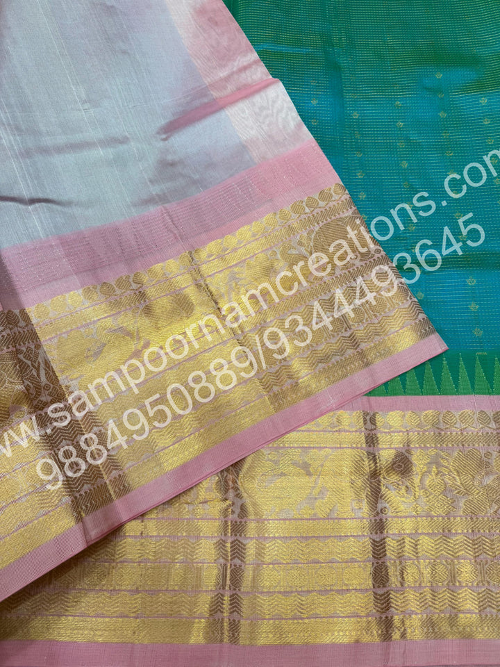 Turquoise Blue with Baby Pink , Rich Zari checks with Floral butta  and Traditional one side long border ,  rich Pallu Pure Korvai Silk Cotton Saree