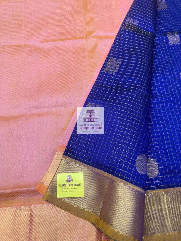 Blue with Baby Pink rich Zari checks in the body ,Mayil and Chakram rich butta in the body, traditional borders and rich Pallu Silk Cotton Saree