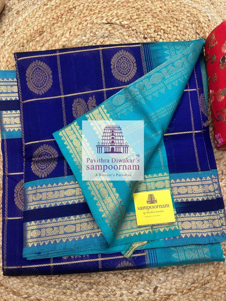 Dark Blue with Blue  , rich Zari checks in the body , Mayil and Chakram rich butta in the body , rettapet borders and rich Pallu Silk Cotton Saree