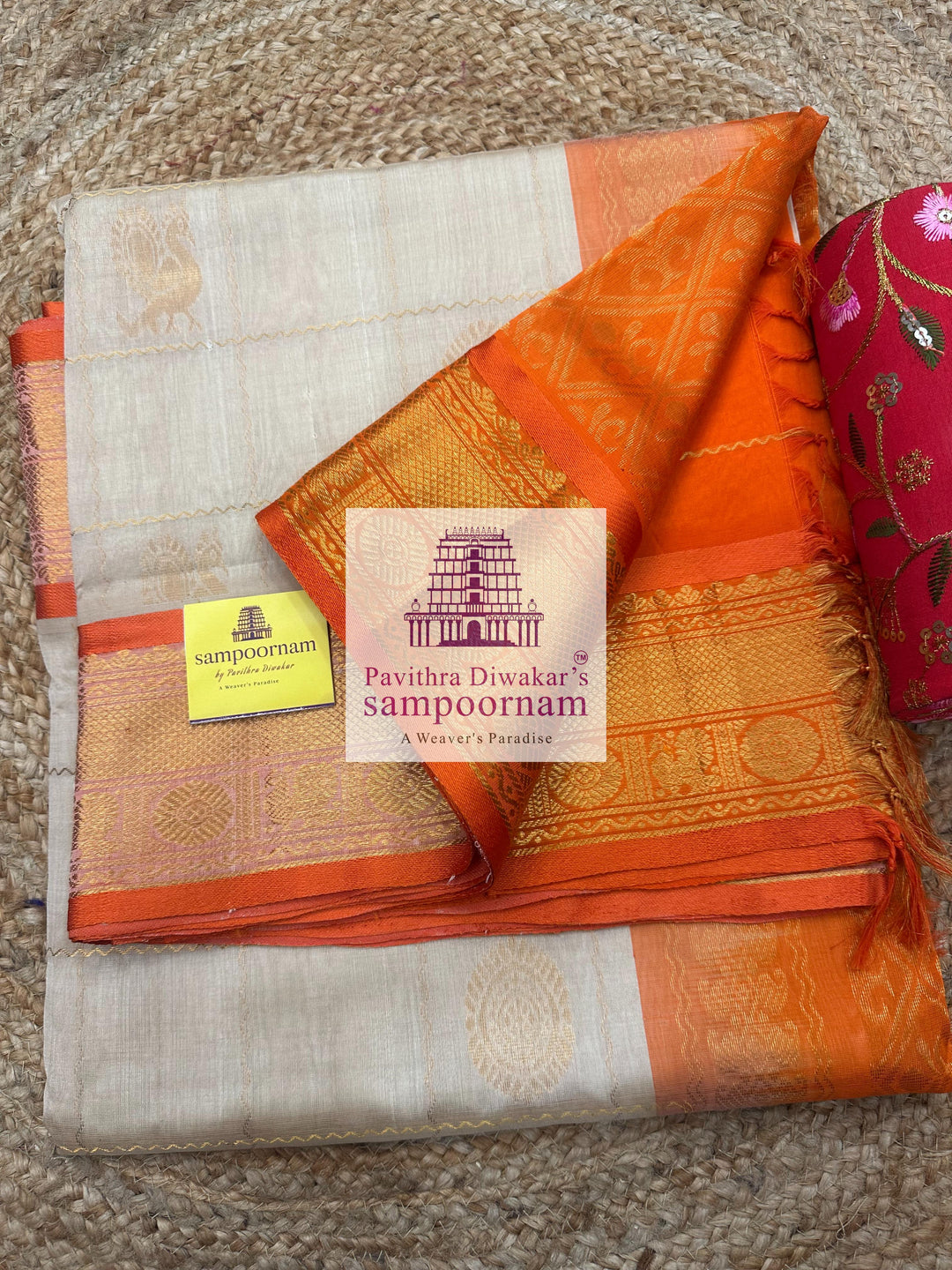 Offwhite with Orange , rich Zari checks in the body , Mayil and Chakram rich butta in the body , traditional borders and rich Pallu Silk Cotton Saree