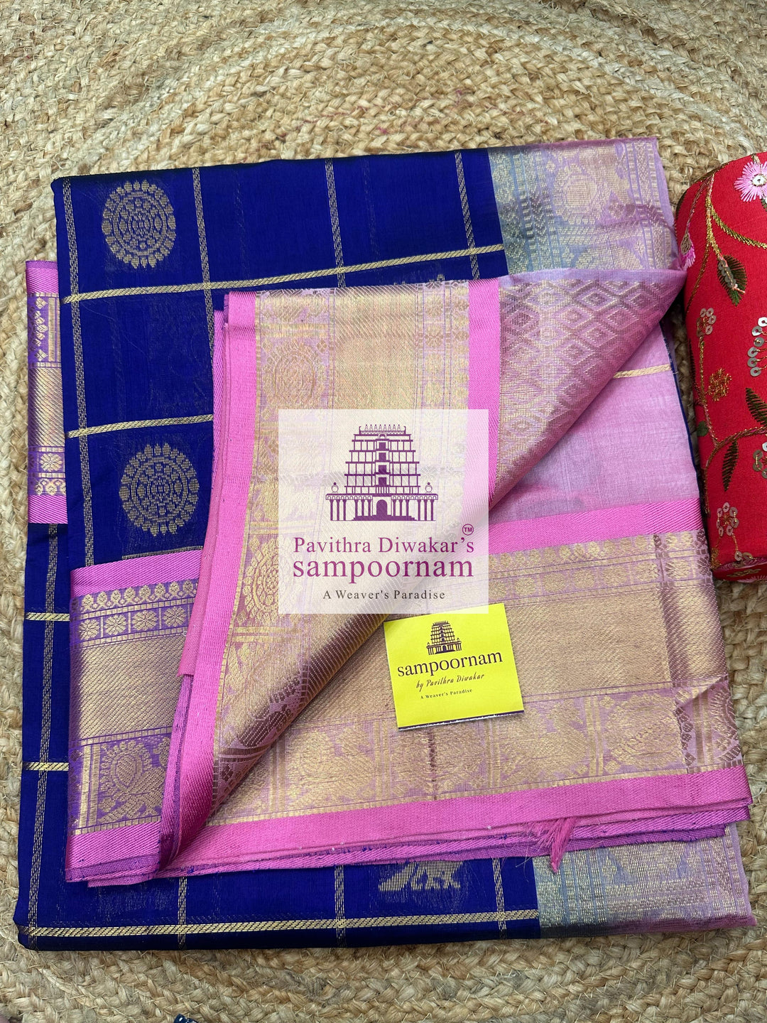 Blue with Baby Pink  , rich Zari checks in the body , Mayil and Chakram rich butta in the body , traditional borders and rich Pallu Silk Cotton Saree