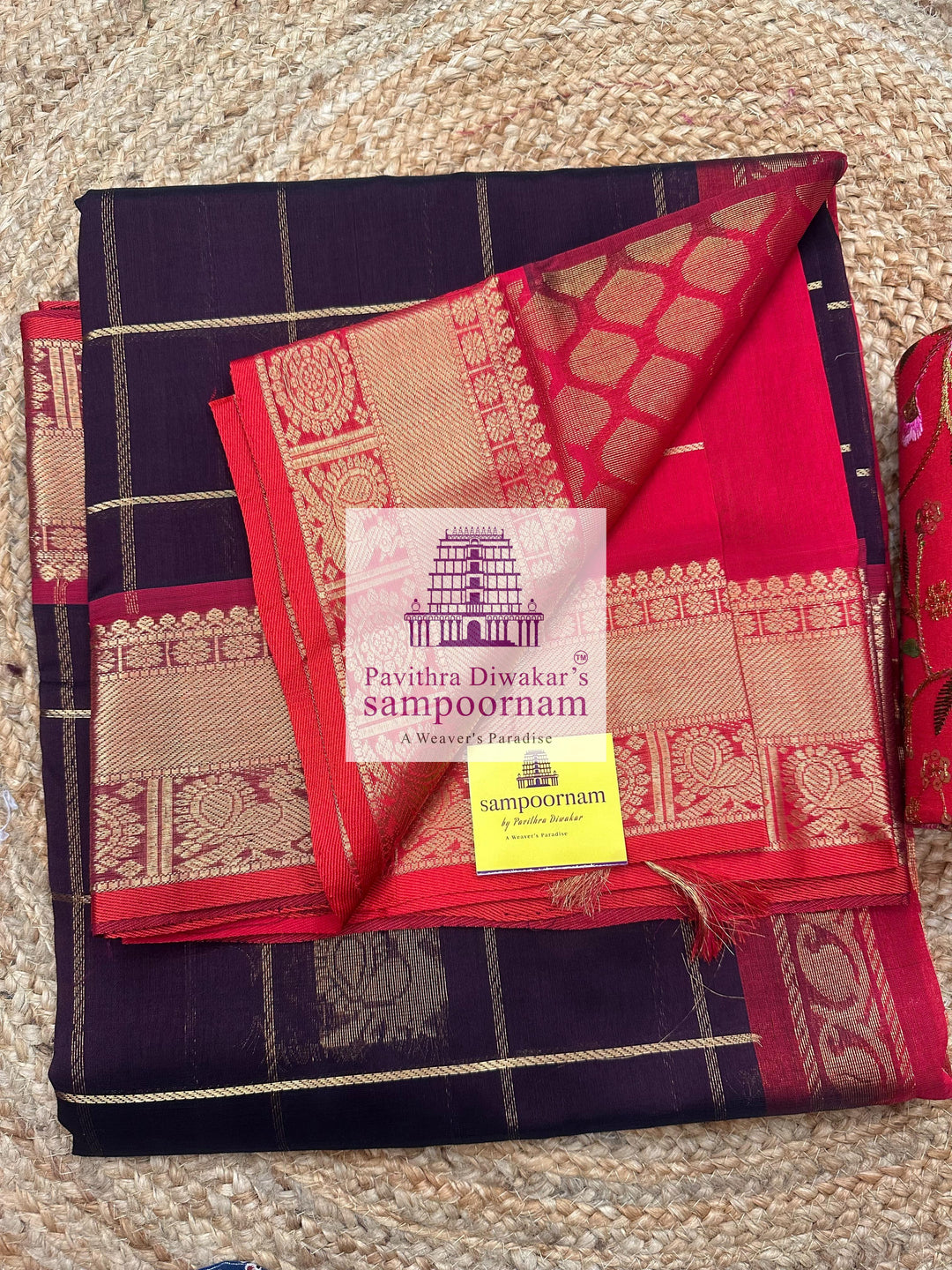 Brown with Red , rich Zari checks in the body , Mayil and Chakram rich butta in the body , traditional borders and rich Pallu Silk Cotton Saree