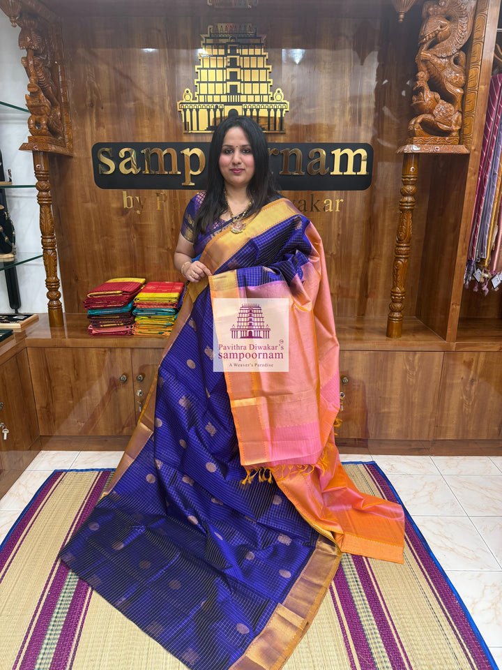 Blue with Baby Pink rich Zari checks in the body ,Mayil and Chakram rich butta in the body, traditional borders and rich Pallu Silk Cotton Saree