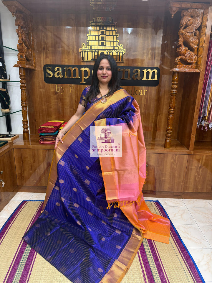Blue with Baby Pink rich Zari checks in the body ,Mayil and Chakram rich butta in the body, traditional borders and rich Pallu Silk Cotton Saree