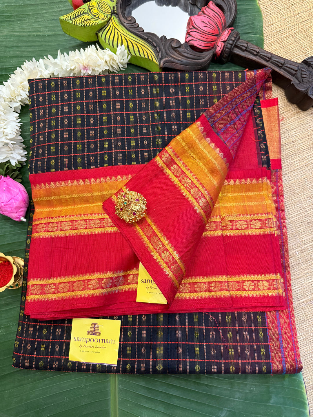 Black with red Lakshadeepam thread butta in the body , rettapet border and rich Pallu Korvai Silk Cotton Saree