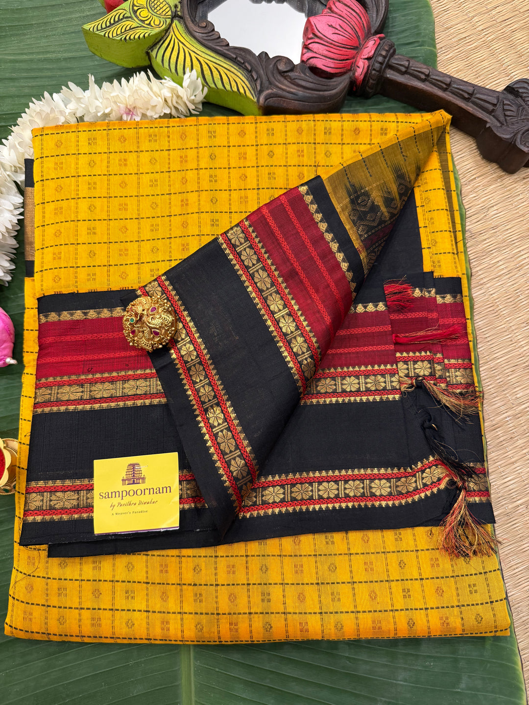 Manjal with Black , Lakshadeepam thread butta in the body , rettapet border and rich Pallu Korvai Silk Cotton Saree