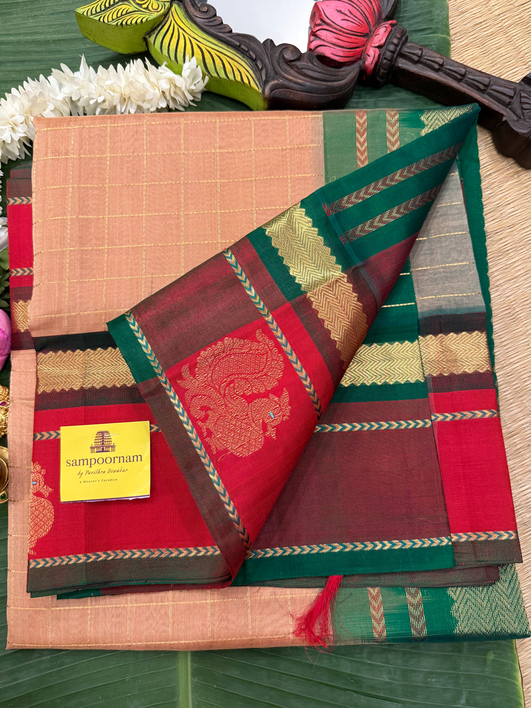 Biscuit colour with Red and Green , rich zari checks in the body , Annam butta in one side border  and grand Pallu Korvai Silk Cotton Saree