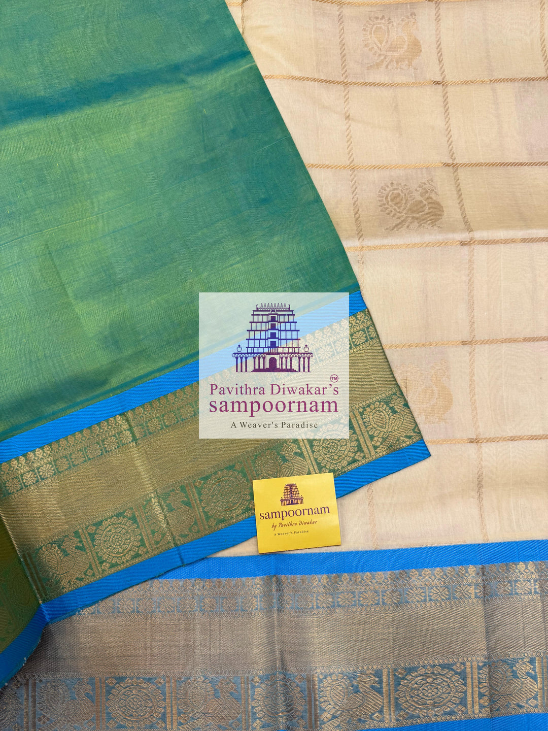 Offwhite  with Blue  , rich Zari checks in the body , Mayil and Chakram rich butta in the body , traditional borders and rich Pallu Silk Cotton Saree