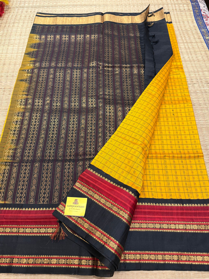 Manjal with Black , Lakshadeepam thread butta in the body , rettapet border and rich Pallu Korvai Silk Cotton Saree