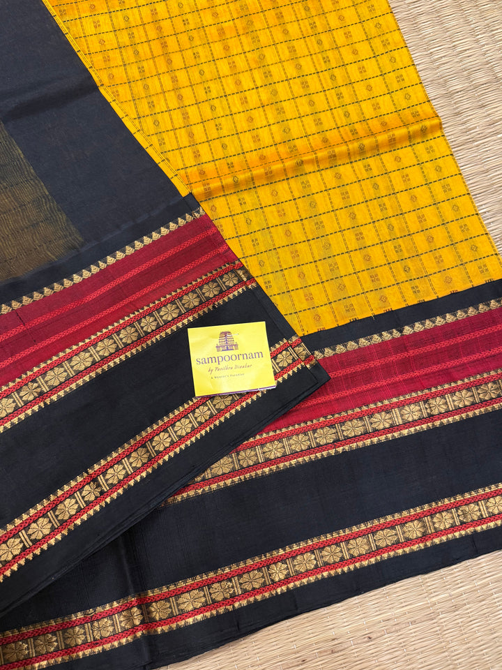 Manjal with Black , Lakshadeepam thread butta in the body , rettapet border and rich Pallu Korvai Silk Cotton Saree
