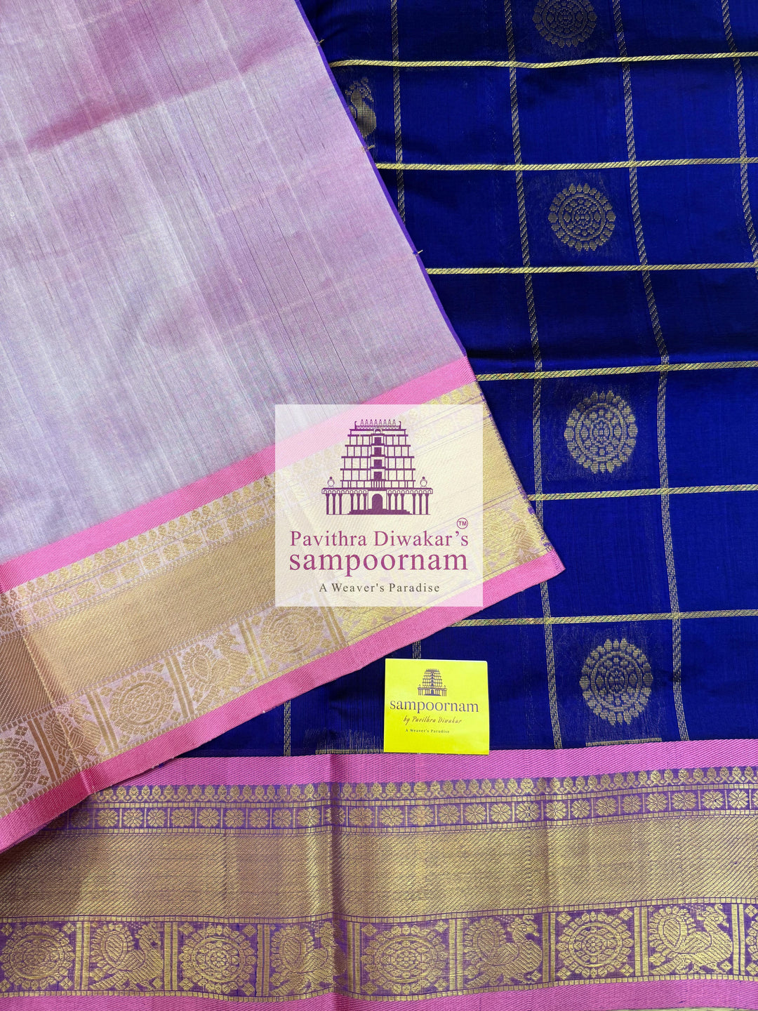 Blue with Baby Pink  , rich Zari checks in the body , Mayil and Chakram rich butta in the body , traditional borders and rich Pallu Silk Cotton Saree