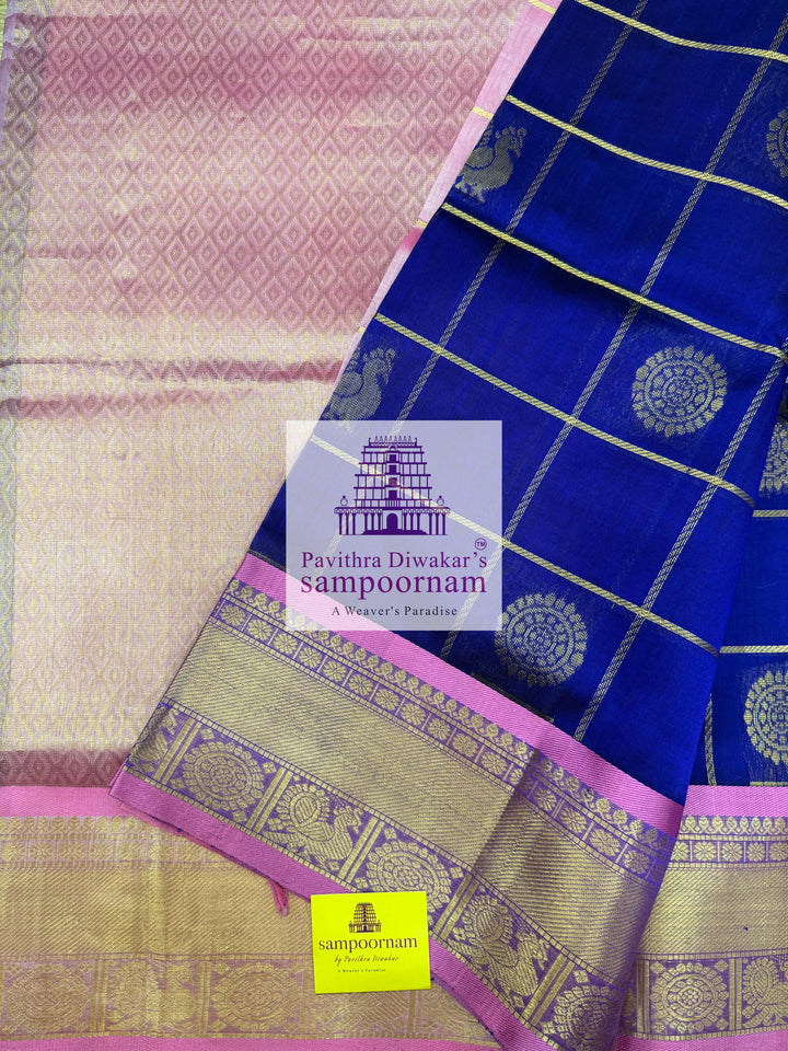Blue with Baby Pink  , rich Zari checks in the body , Mayil and Chakram rich butta in the body , traditional borders and rich Pallu Silk Cotton Saree