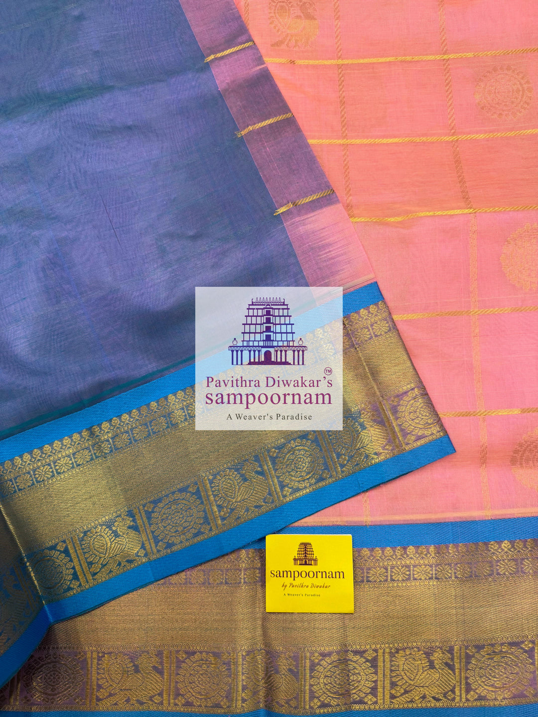Baby Pink with Blue  , rich Zari checks in the body , Mayil and Chakram rich butta in the body , traditional borders and rich Pallu Silk Cotton Saree