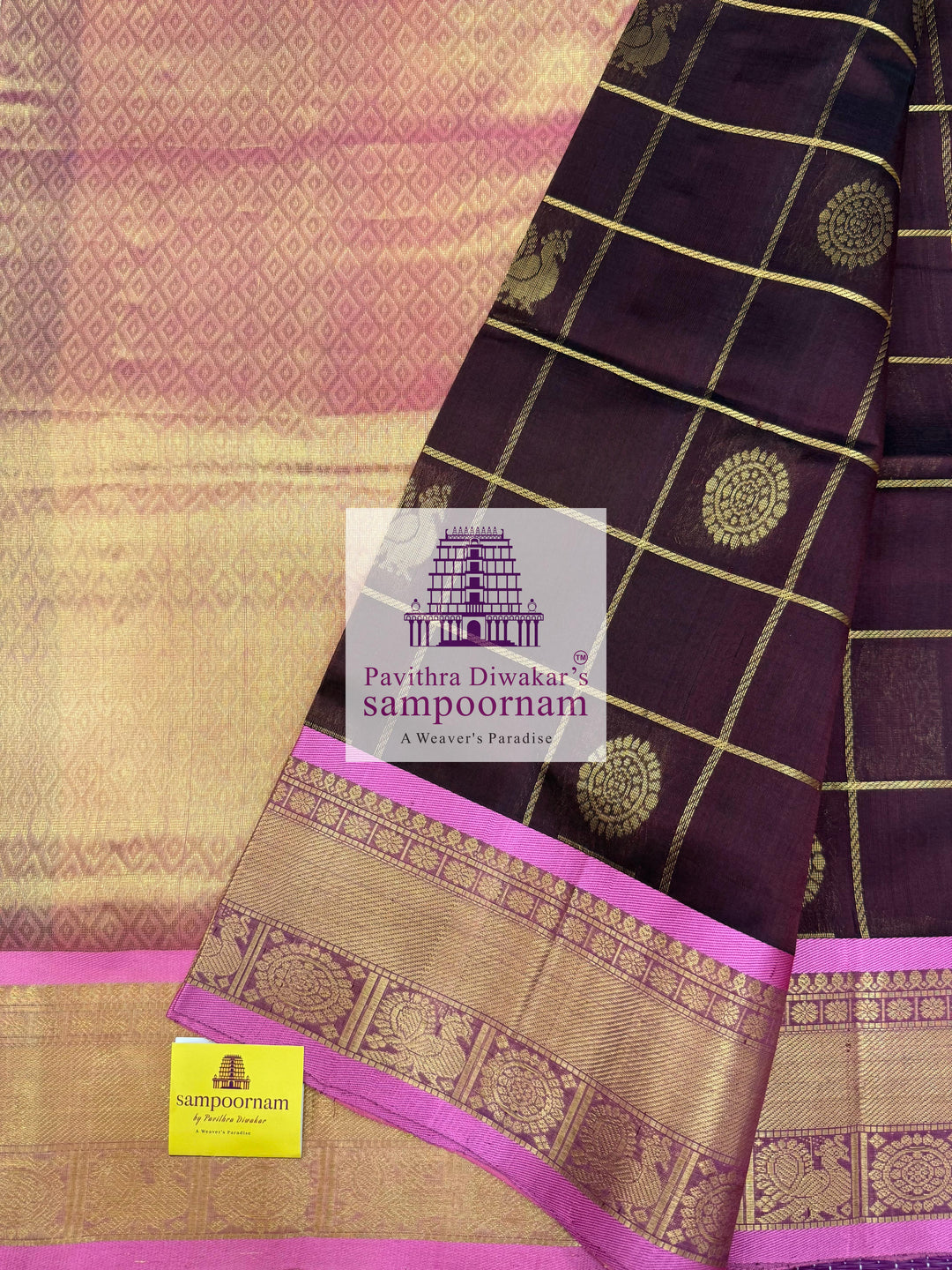 Brown with Peachish Pink, Baby Pink Selvedge , rich Zari checks in the body , Mayil and Chakram rich butta in the body , traditional borders and rich Pallu Silk Cotton Saree