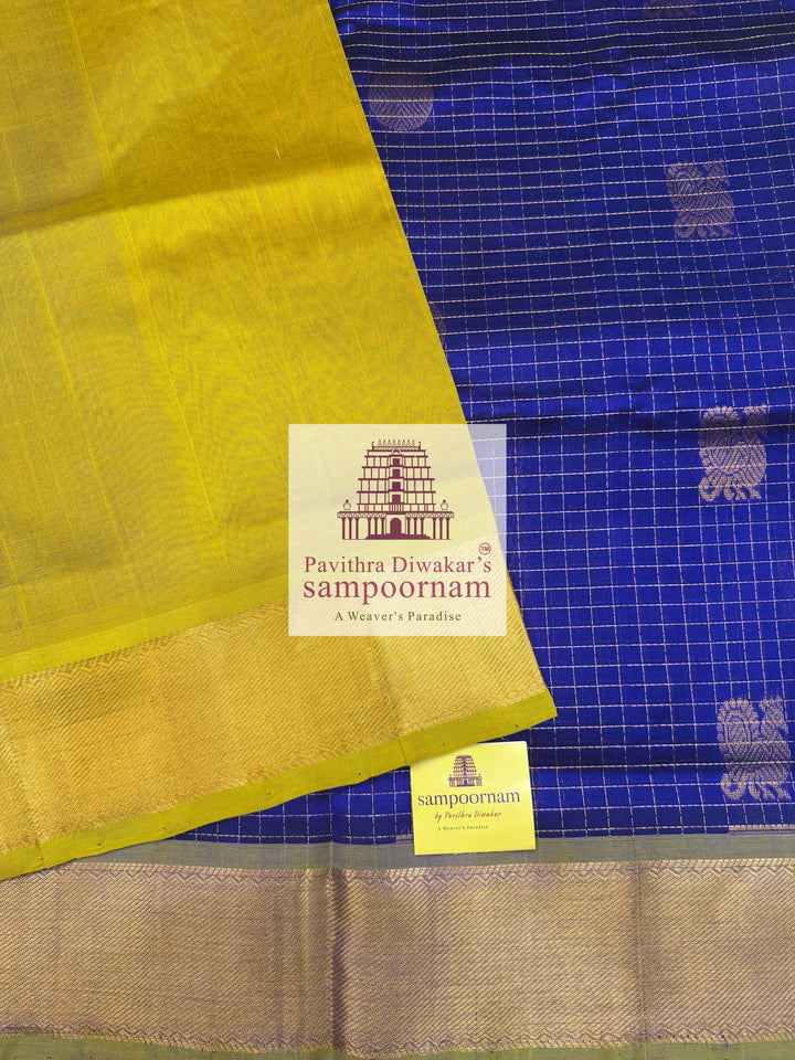 Blue with Lemon Yellow , rich Zari checks in the body , Mayil and Chakram rich butta in the body , traditional borders and rich Pallu Silk Cotton Saree