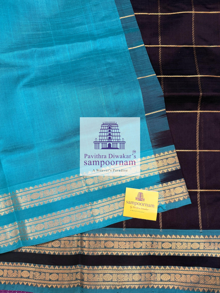 Black with Turquoise Blue , rich Zari checks in the body , Mayil and Chakram rich butta in the body , rettapet  borders and rich Pallu Silk Cotton Saree