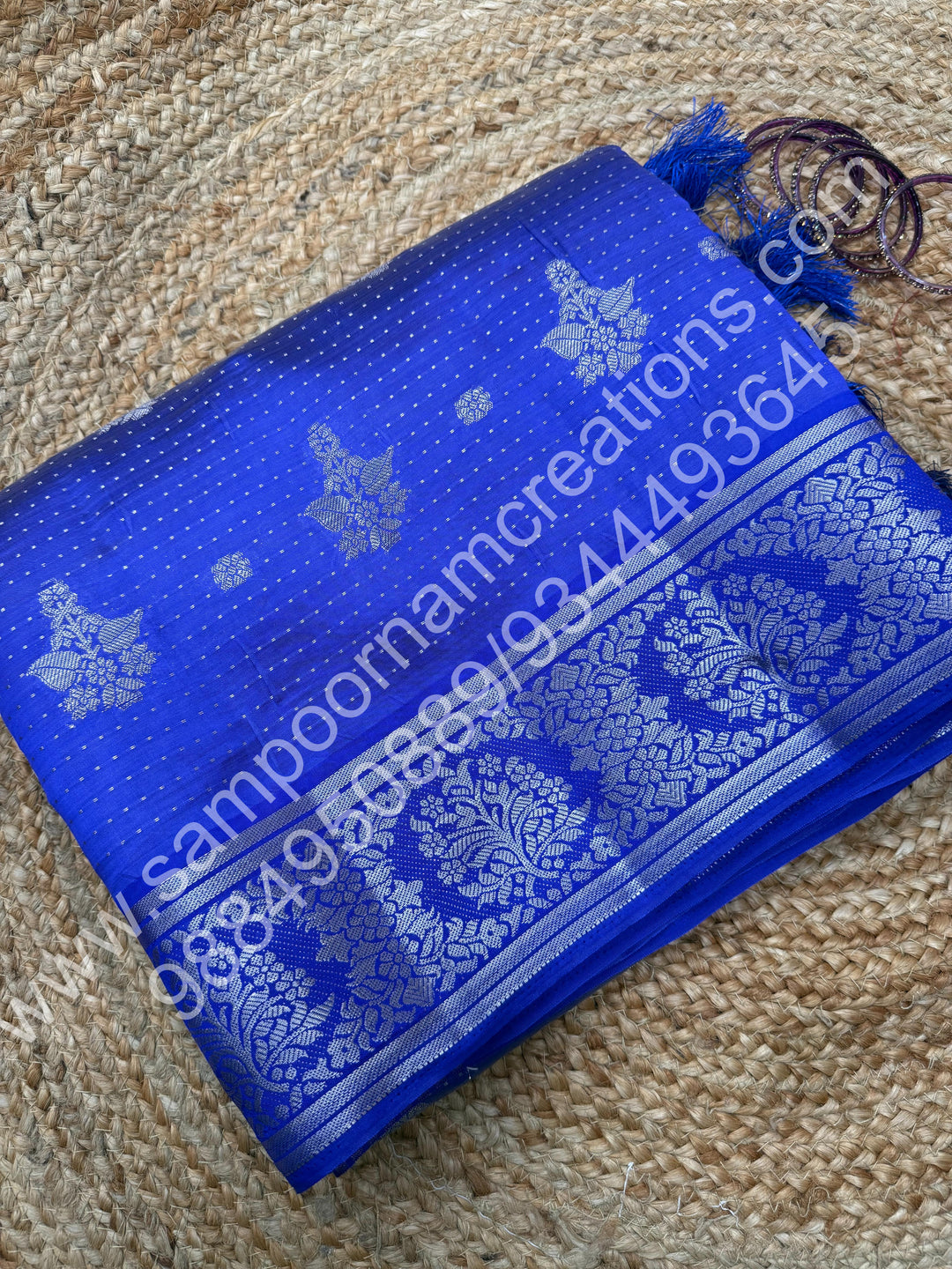 Indigo Blue , Silver Floral buttas in the body with Silver Zari Border , Tissue Pallu and Tissue Blouse  , Semi Tussar Saree