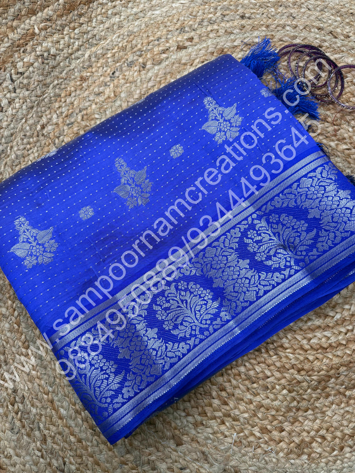 Indigo Blue , Silver Floral buttas in the body with Silver Zari Border , Tissue Pallu and Tissue Blouse  , Semi Tussar Saree