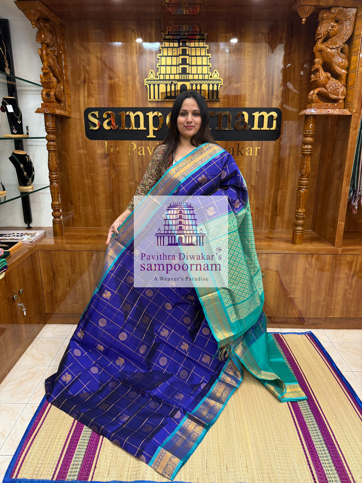 Dark Blue with Turquoise Blue  , rich Zari checks in the body , Mayil and Chakram rich butta in the body , traditional borders and rich Pallu Silk Cotton Saree