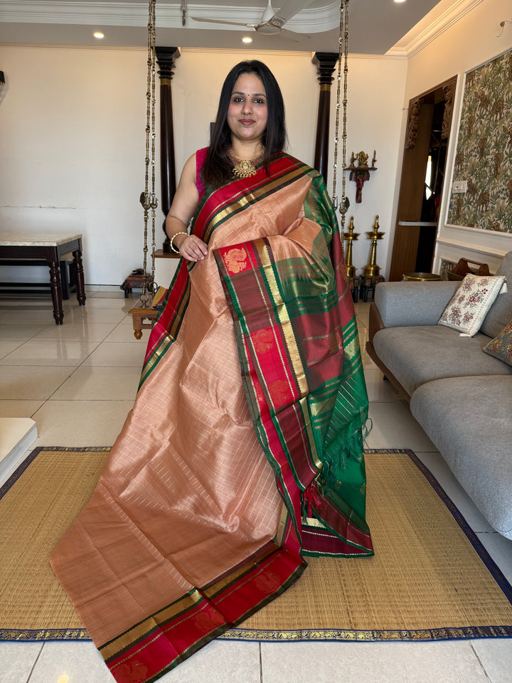 Biscuit colour with Red and Green , rich zari checks in the body , Annam butta in one side border  and grand Pallu Korvai Silk Cotton Saree