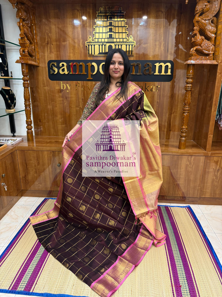 Brown with Peachish Pink, Baby Pink Selvedge , rich Zari checks in the body , Mayil and Chakram rich butta in the body , traditional borders and rich Pallu Silk Cotton Saree