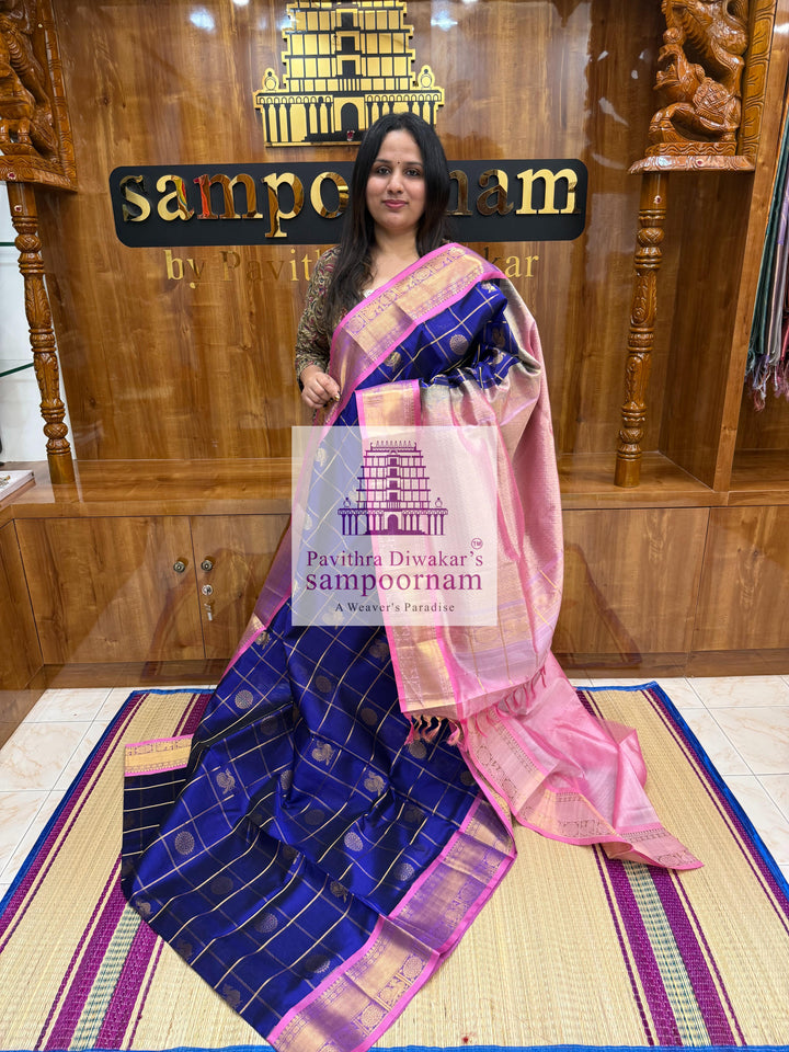 Blue with Baby Pink  , rich Zari checks in the body , Mayil and Chakram rich butta in the body , traditional borders and rich Pallu Silk Cotton Saree