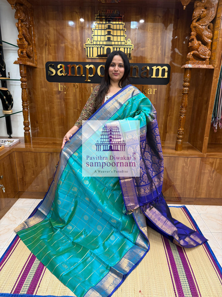Ramar Green with Blue  , rich Zari checks in the body , Mayil and Chakram rich butta in the body , traditional borders and rich Pallu Silk Cotton Saree