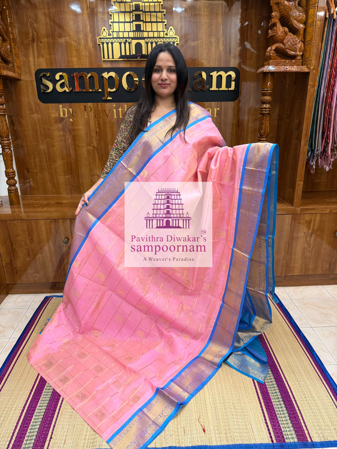 Baby Pink with Blue  , rich Zari checks in the body , Mayil and Chakram rich butta in the body , traditional borders and rich Pallu Silk Cotton Saree