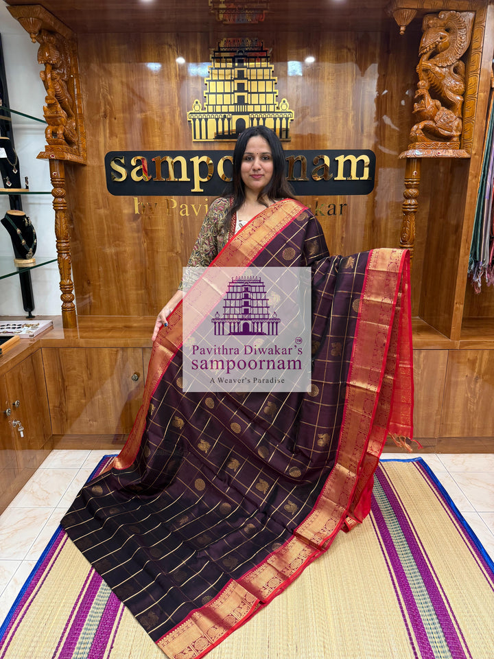 Brown with Red , rich Zari checks in the body , Mayil and Chakram rich butta in the body , traditional borders and rich Pallu Silk Cotton Saree