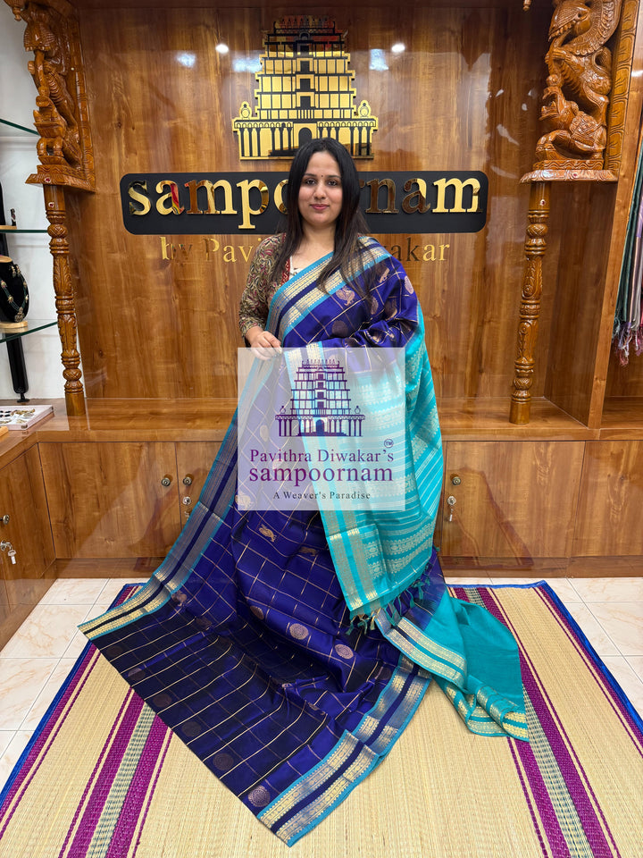 Dark Blue with Blue  , rich Zari checks in the body , Mayil and Chakram rich butta in the body , rettapet borders and rich Pallu Silk Cotton Saree