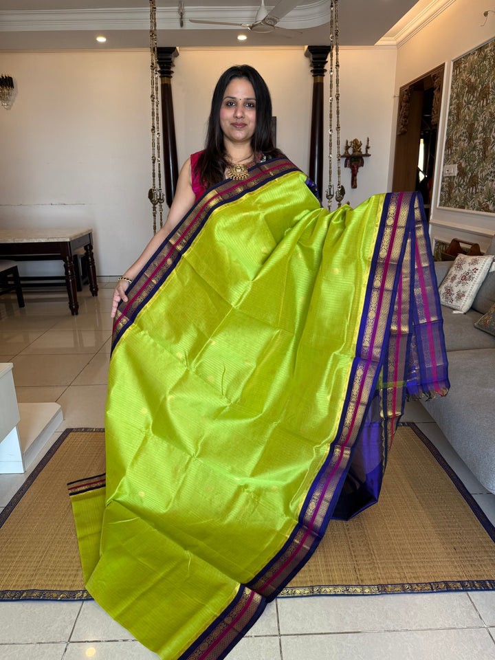Fluorescent Green with Blue, rich zari butta and vertical zari lines in the body, traditional borders  and rich Pallu Korvai Silk Cotton Saree