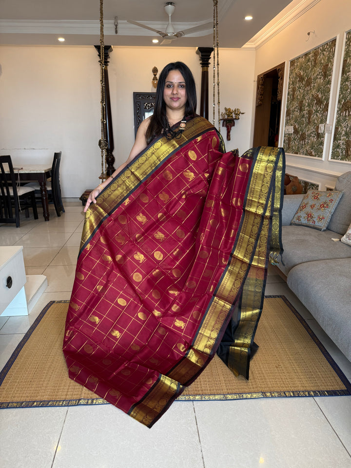 Maroon with Black  , zari kattam in the body with Mayil and Chakram butta ,traditional borders and rich Pallu Silk Cotton Saree