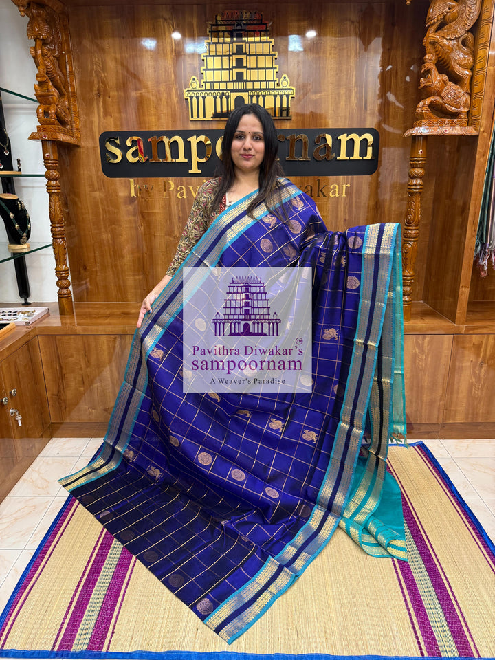 Dark Blue with Blue  , rich Zari checks in the body , Mayil and Chakram rich butta in the body , rettapet borders and rich Pallu Silk Cotton Saree