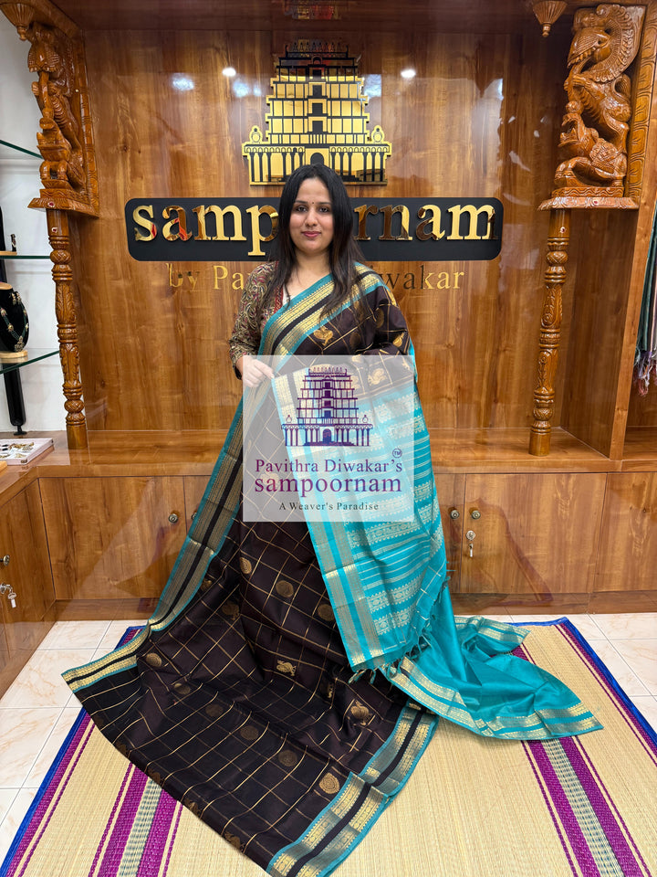 Black with Turquoise Blue , rich Zari checks in the body , Mayil and Chakram rich butta in the body , rettapet  borders and rich Pallu Silk Cotton Saree