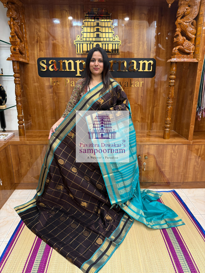 Black with Turquoise Blue , rich Zari checks in the body , Mayil and Chakram rich butta in the body , rettapet  borders and rich Pallu Silk Cotton Saree