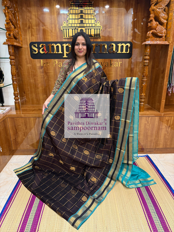 Black with Turquoise Blue , rich Zari checks in the body , Mayil and Chakram rich butta in the body , rettapet  borders and rich Pallu Silk Cotton Saree