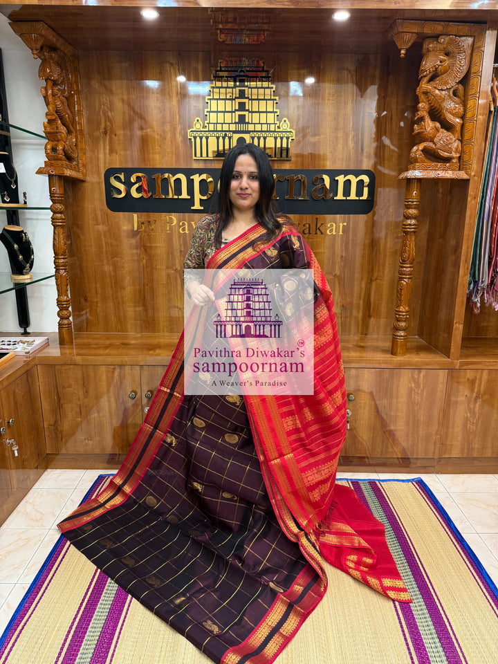 Brown with Red , rich Zari checks in the body , Mayil and Chakram rich butta in the body , rettapet borders and rich Pallu Silk Cotton Saree