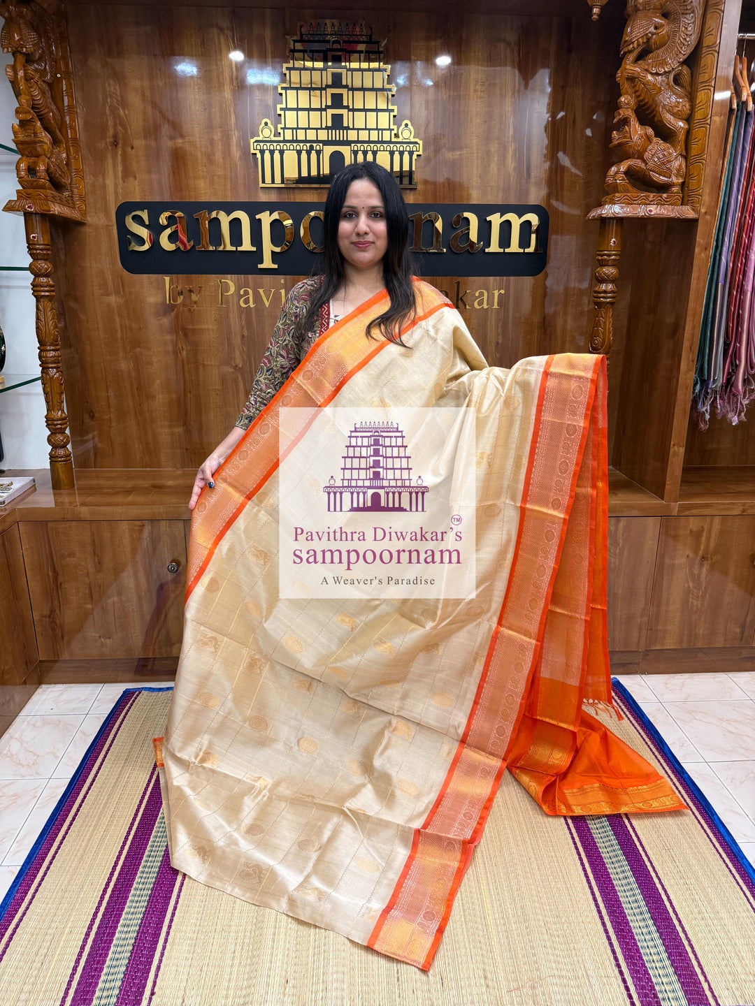 Offwhite with Orange , rich Zari checks in the body , Mayil and Chakram rich butta in the body , traditional borders and rich Pallu Silk Cotton Saree