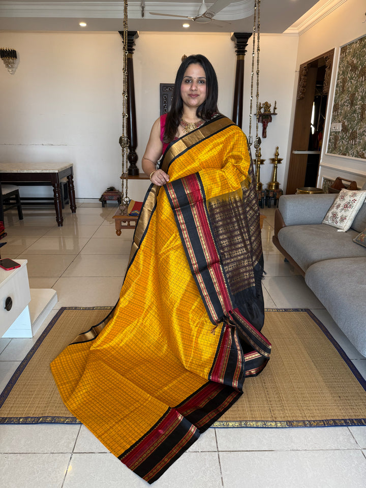 Manjal with Black , Lakshadeepam thread butta in the body , rettapet border and rich Pallu Korvai Silk Cotton Saree