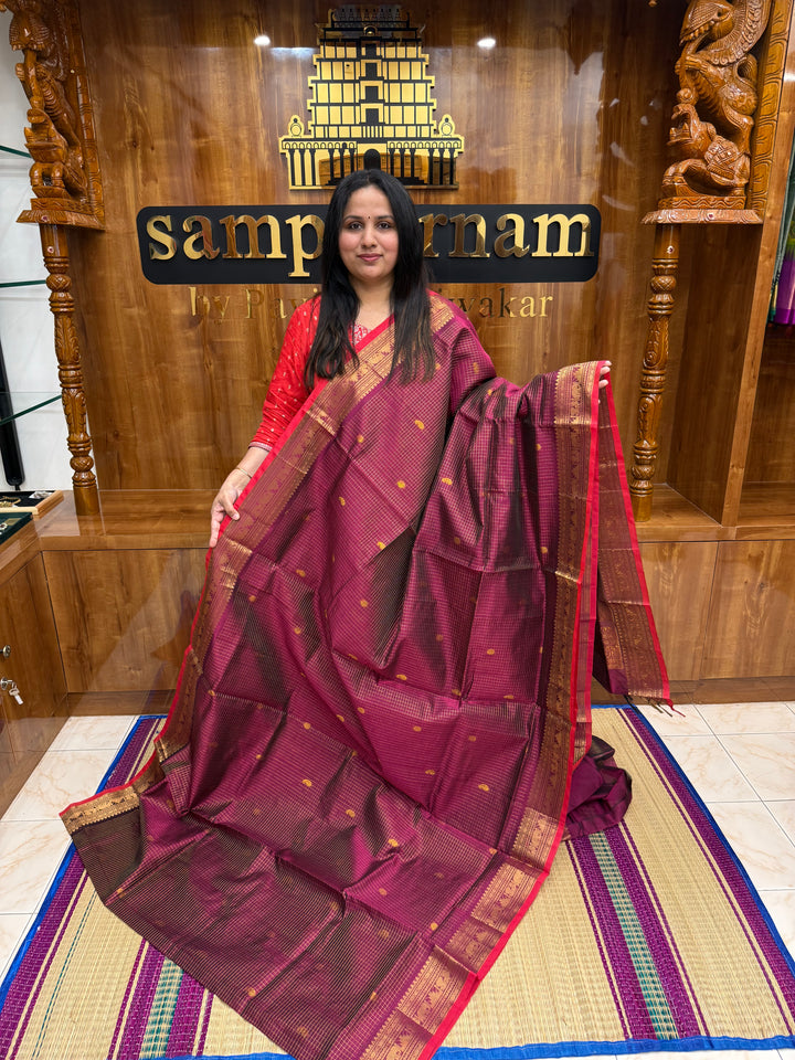 Dark magenta with Red Selvedge, Zari Kattam in the Body with Rich Butta, Traditional Borders and Rich Pallu Semi Silk Cotton Saree