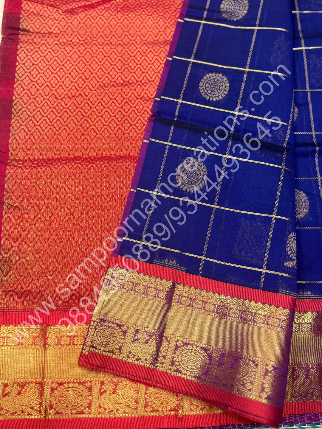 Dark Blue with Red , Rich Mayil and Chakram butta in the body with Zari Checks , Traditional borders and Rich Pallu Pure Silk Cotton Saree