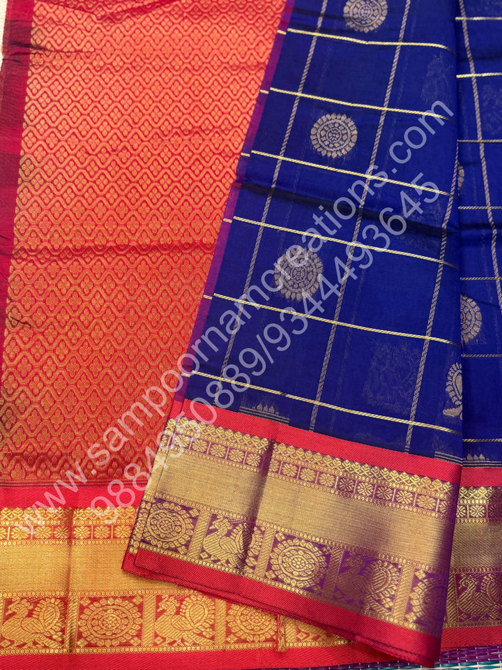 Dark Blue with Red , Rich Mayil and Chakram butta in the body with Zari Checks , Traditional borders and Rich Pallu Pure Silk Cotton Saree